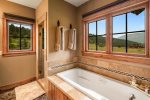 Master ensuite-jetted soaking tub-standing shower-walk in closet-toilet room